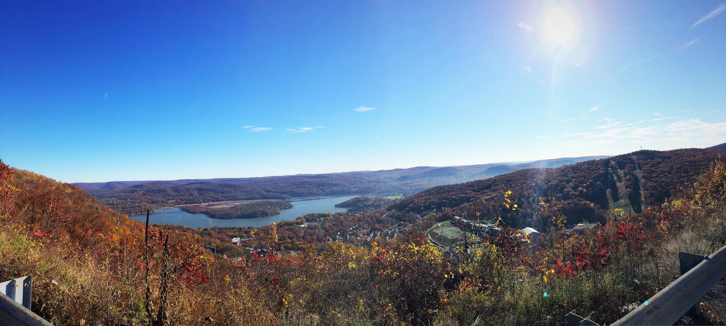 A wide view over the Hudson Valley and river from a hilltop overlook in autumn