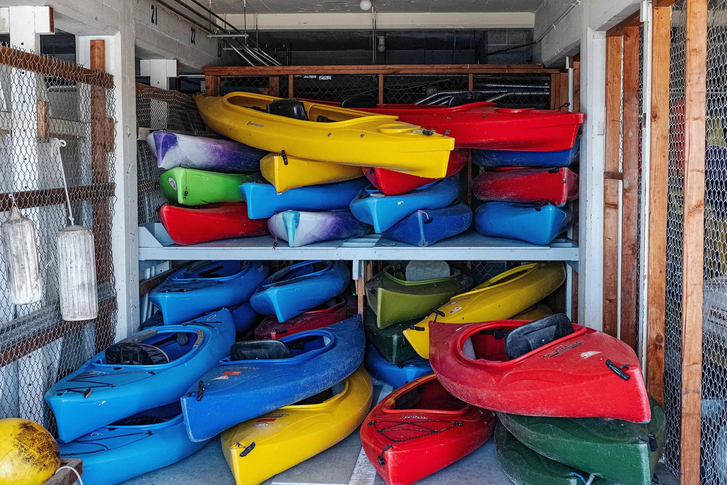 Rows of colorful kayaks stacked on storage racks